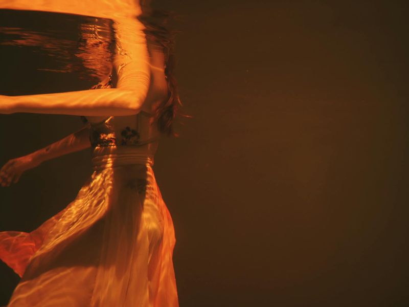 Person doing fluid arm movements in a minimalist room